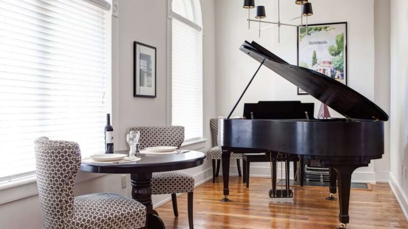 Well decorated living space with a grand piano 